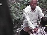 Grandpa With Asian Prostitute In The Woods