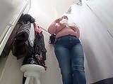 A hidden camera in a public fitting room, a fat milf disguises herself.