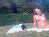 Nudist milf relaxing and tanning